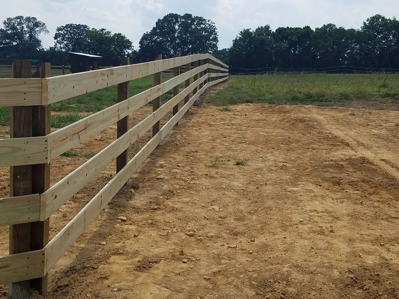 4-rail wood ranch fence installed by Hooks Fence Company in Oneonta, Alabama