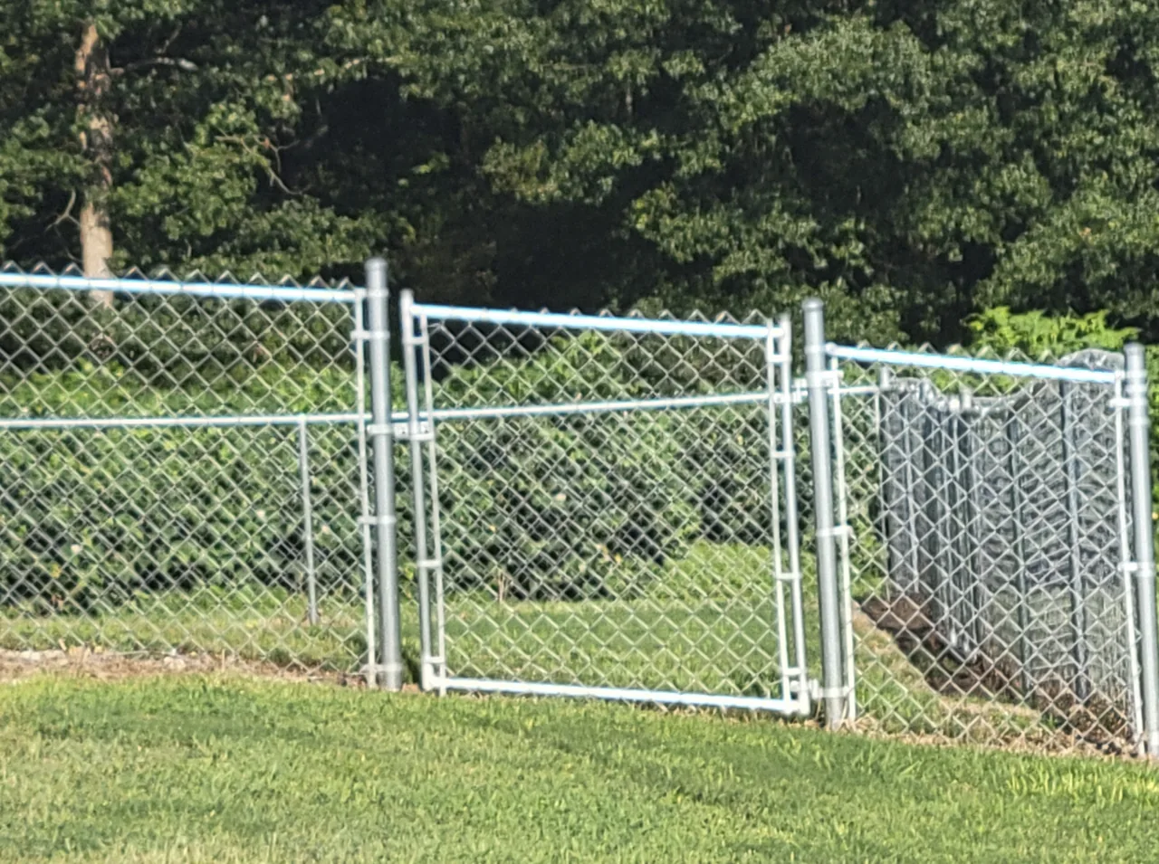 Custom chain-link gate built to follow sloped ground in Blountsville Alabama by Hooks Fence Company