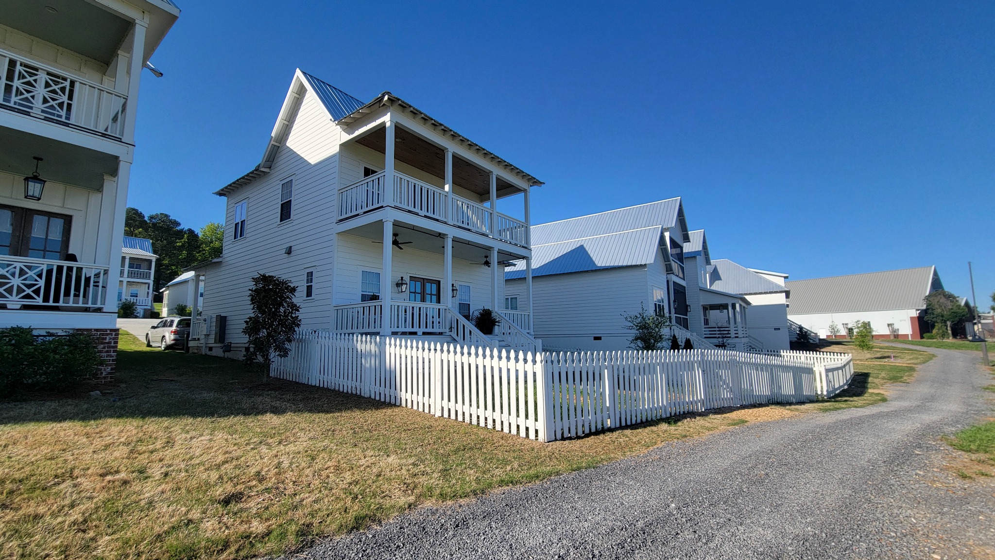 Finished white picket fence in Guntersville, Alabama installed by Hooks Fence Company