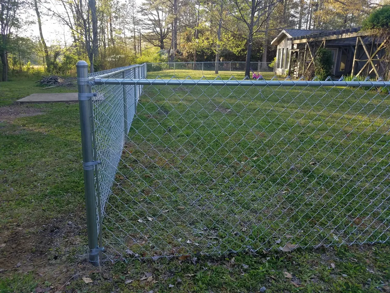 Galvanized chain-link fence corner and terminal post installed in Carlisle Alabama