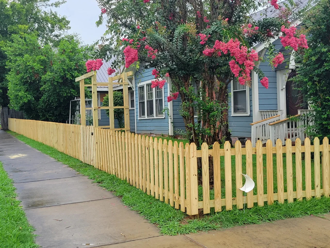 Natural wood picket fence in Attalla, Alabama installed by Hooks Fence Company